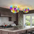 Modern kitchen with semi flush mounted colorful bubble light fixtures and a window view.